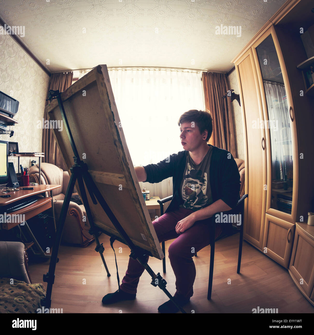 Caucasian artist painting in bedroom Stock Photo Alamy