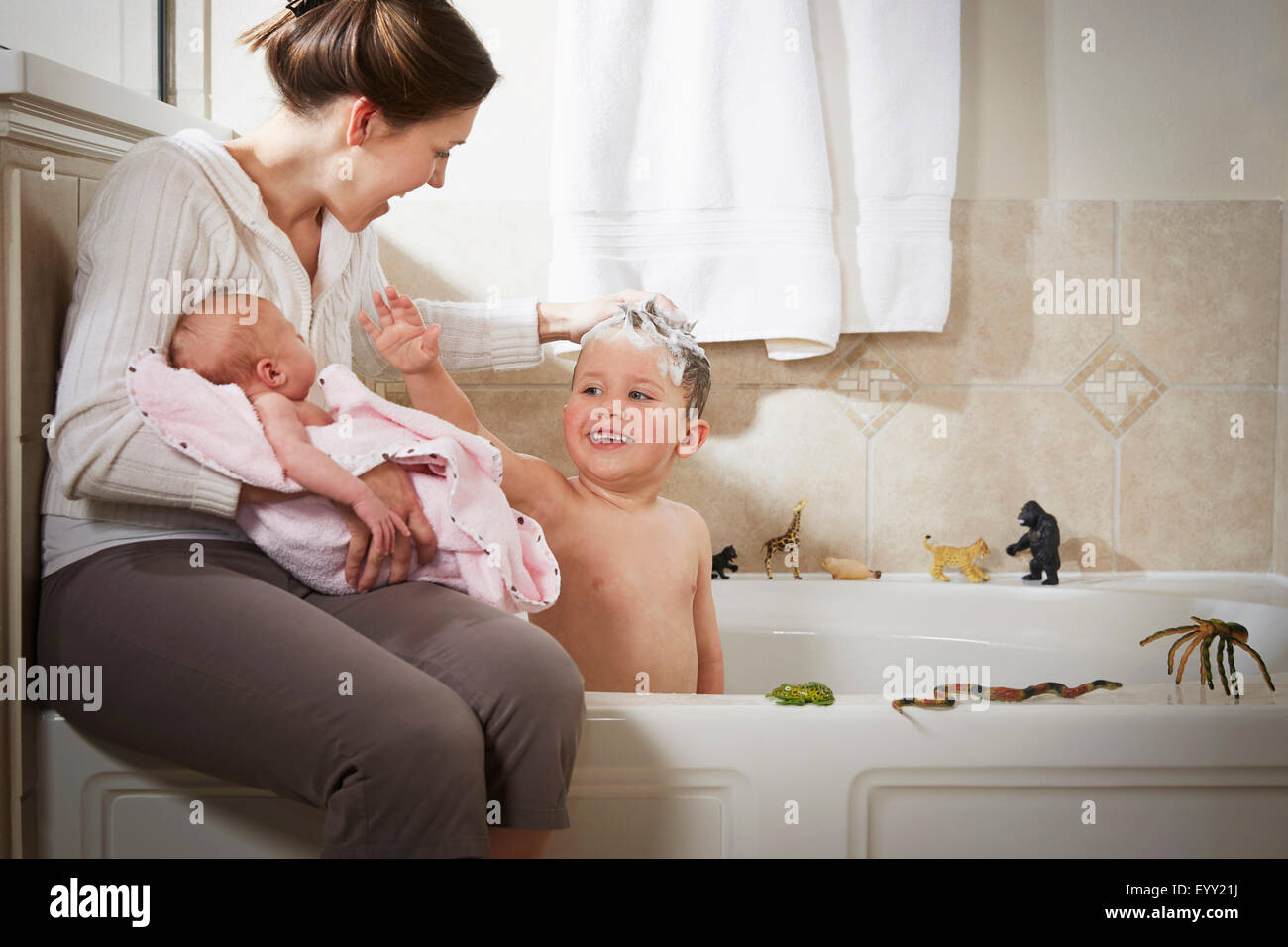 Caucasian mother and newborn washing son in bath Stock Photo Alamy