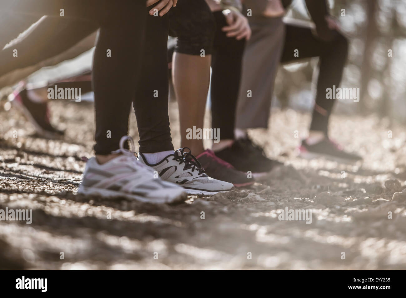 Close up of runners stretching in a row Stock Photo