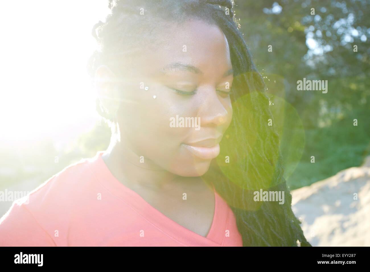 Close up of African American woman with eyes closed Stock Photo