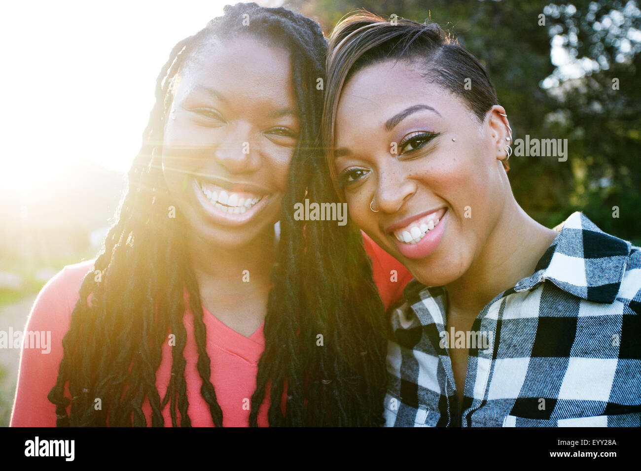 Smiling women hugging outdoors Stock Photo