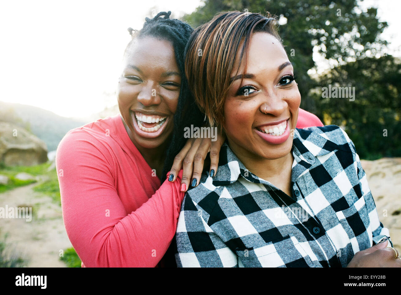 Smiling women hugging outdoors Stock Photo