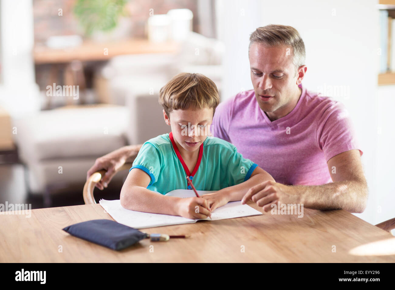 Caucasian father and son drawing at table Stock Photo