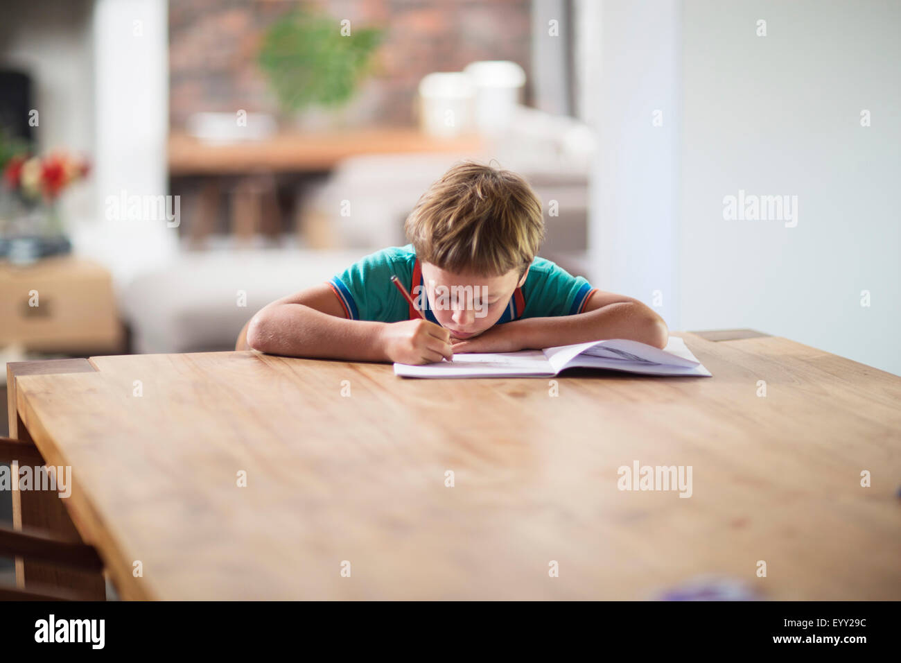 Caucasian boy drawing at table Stock Photo