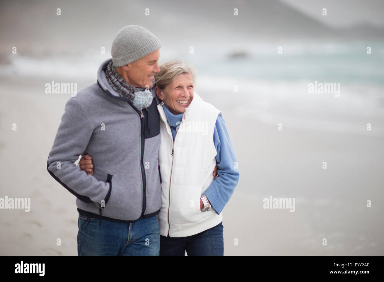 Caucasian couple hugging on beach Stock Photo