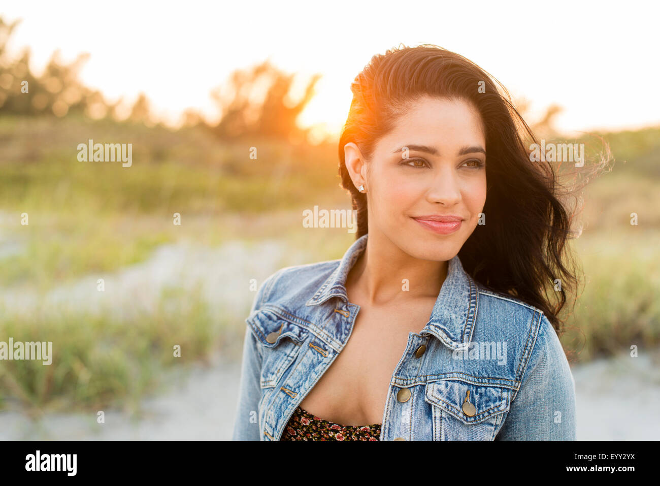 Hispanic woman standing on beach Stock Photo
