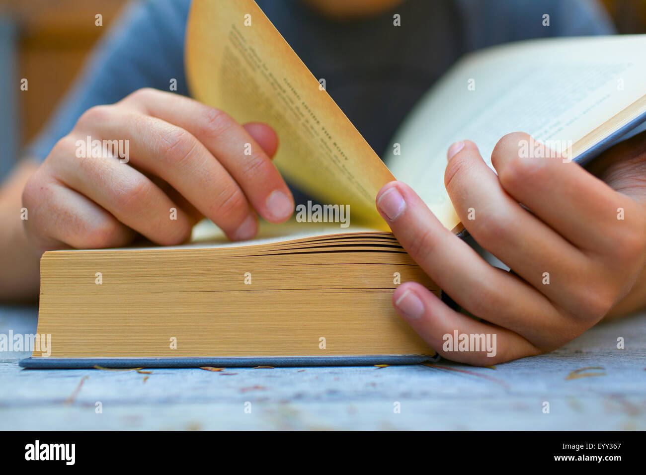 Close up of Hispanic man turning book pages Stock Photo