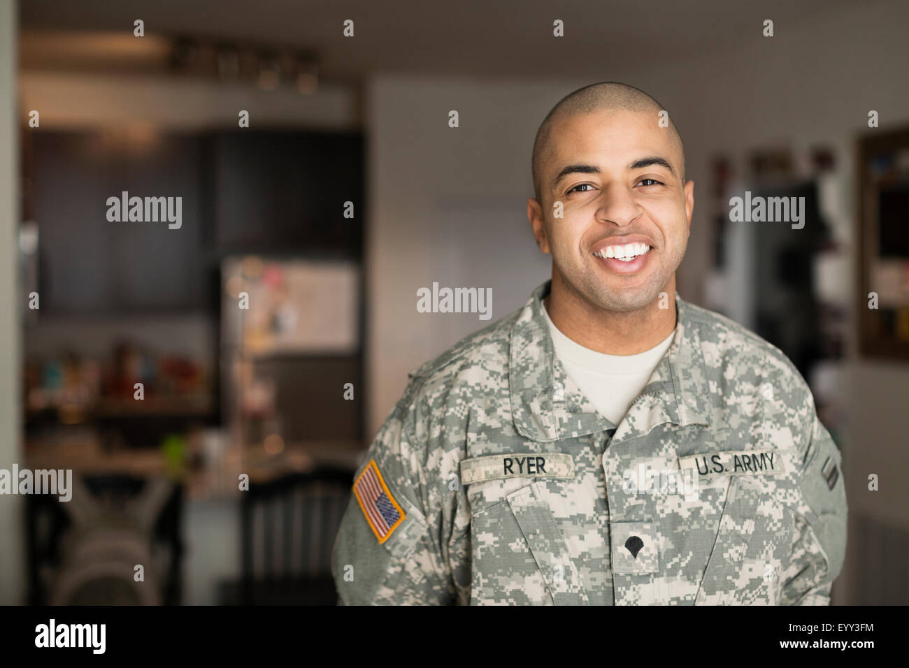 Mixed race man smiling in living room Stock Photo