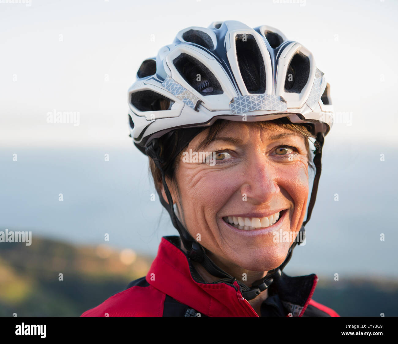 Woman wearing bicycle helmet hi-res stock photography and images - Alamy