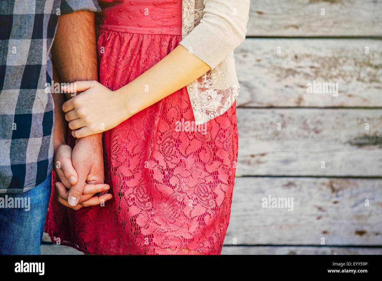 Close up of Caucasian couple holding hands Stock Photo