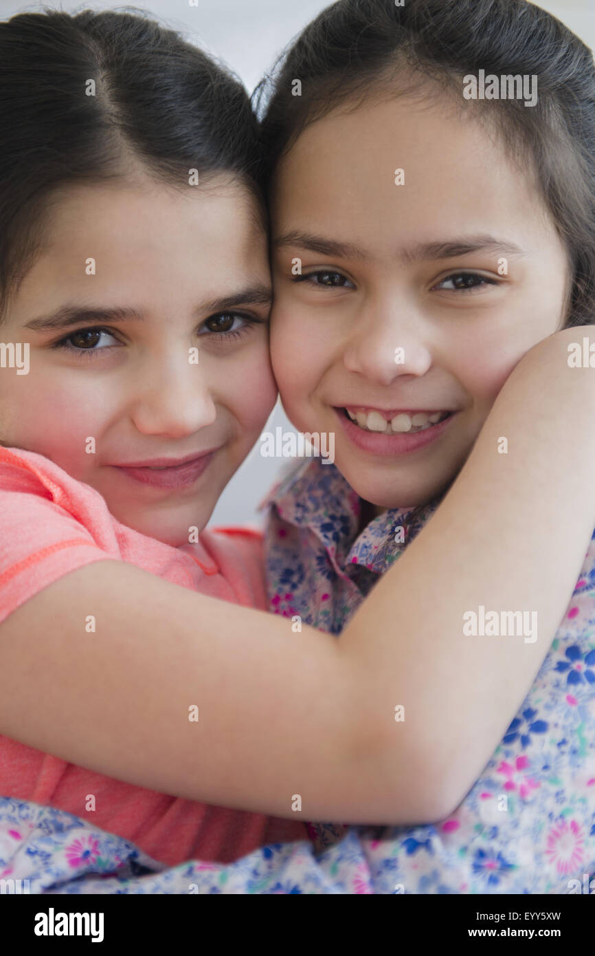 Close up of Caucasian sisters hugging Stock Photo