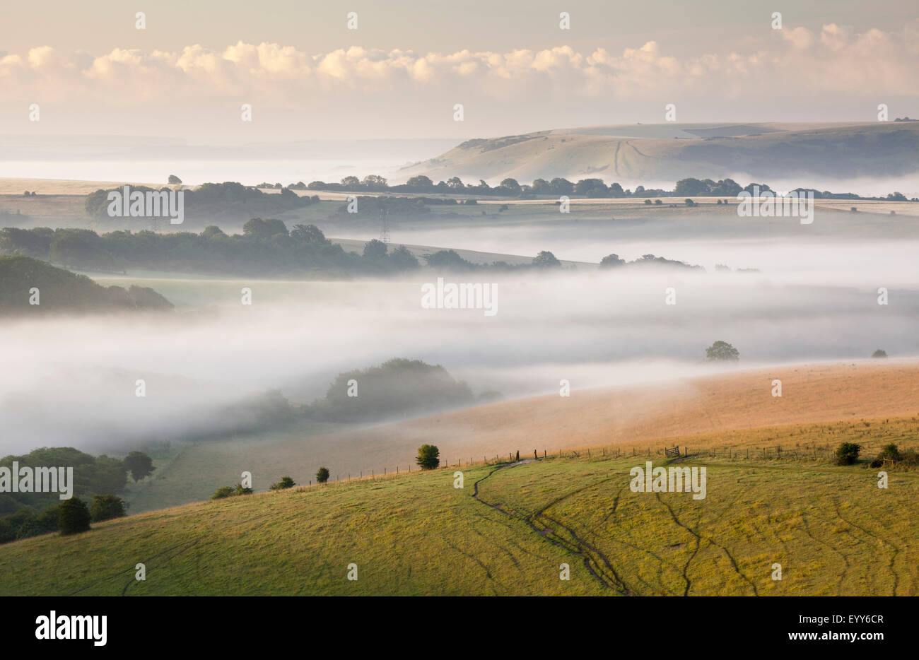 Early morning mist hanging over the South Downs near Ditchling Beacon. Stock Photo