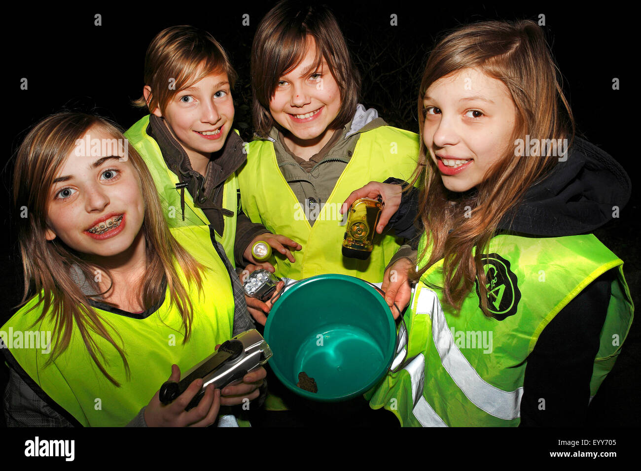 close to nature children helping at the toads migrating, Belgium Stock Photo