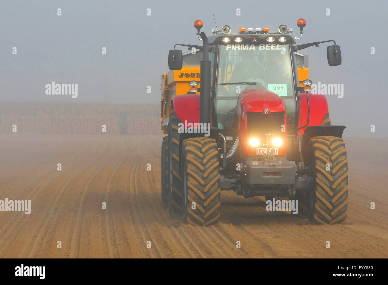 tractor with container on a field, Belgium Stock Photo