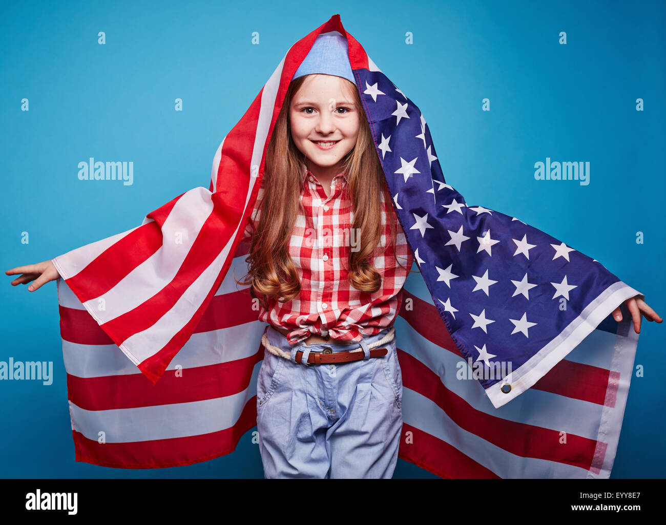 Cheerful girl with flag of USA looking at camera Stock Photo - Alamy