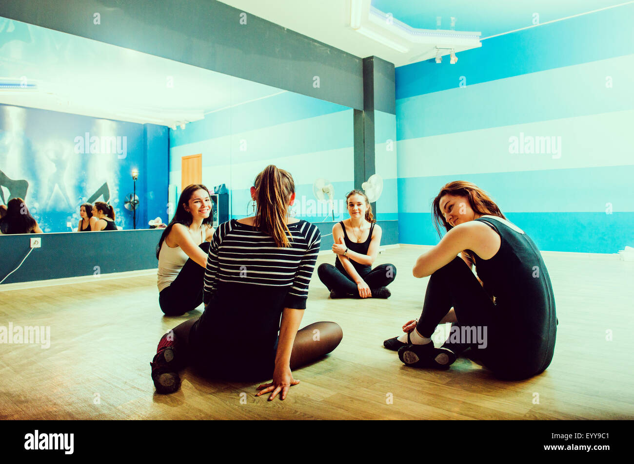 Caucasian dancers sitting on studio floor Stock Photo Alamy