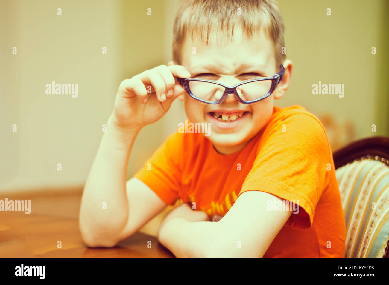 Caucasian boy peering over glasses Stock Photo