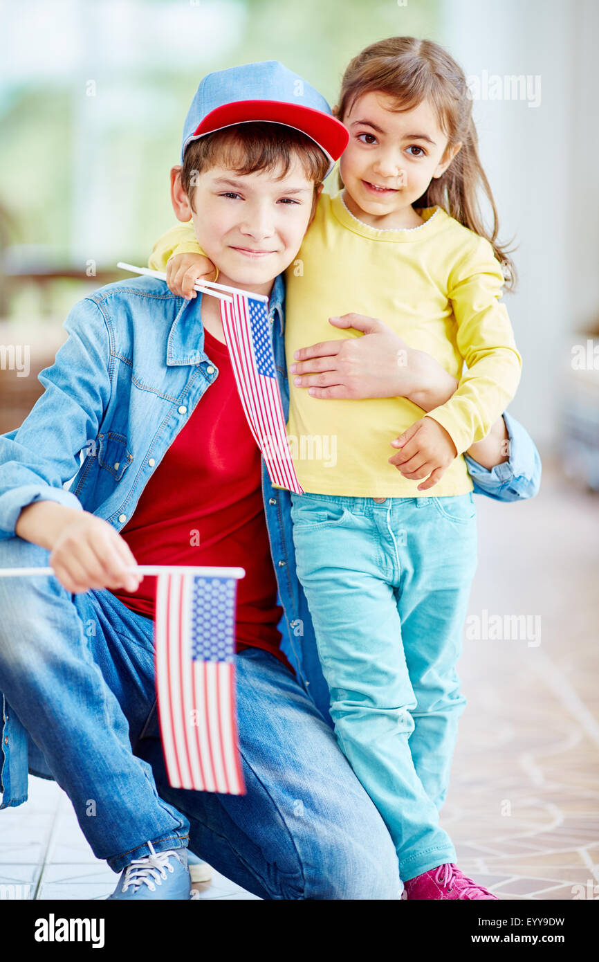 Happy boy and girl with American flags Stock Photo - Alamy