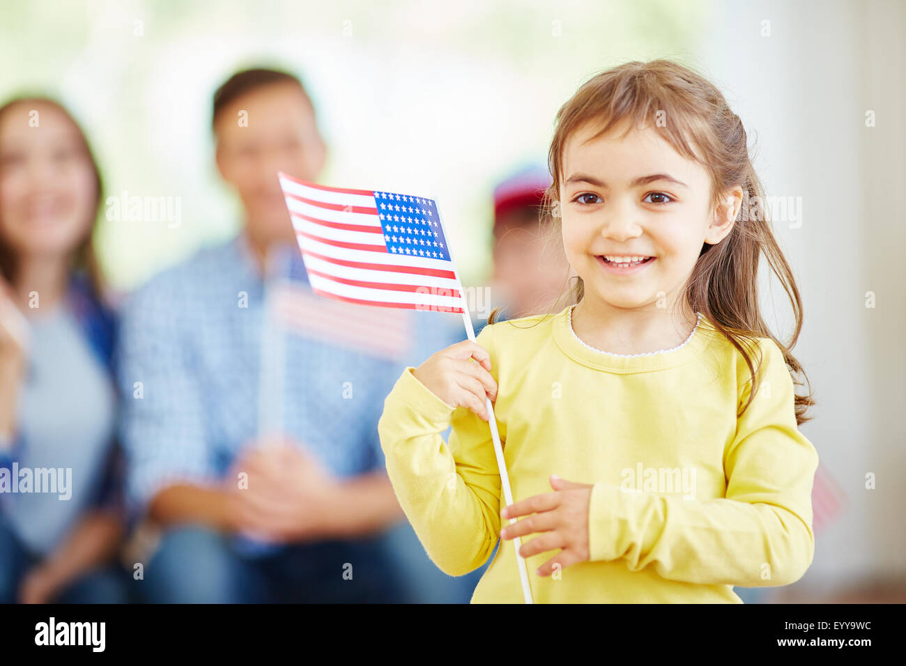 Happy little girl holding American flag Stock Photo - Alamy