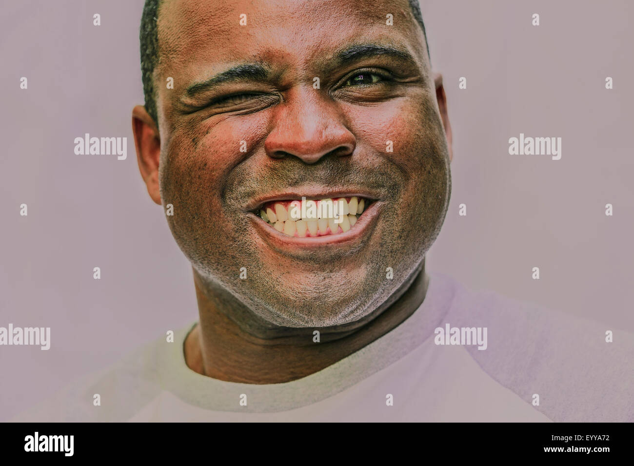 Close up of grinning Black man winking Stock Photo