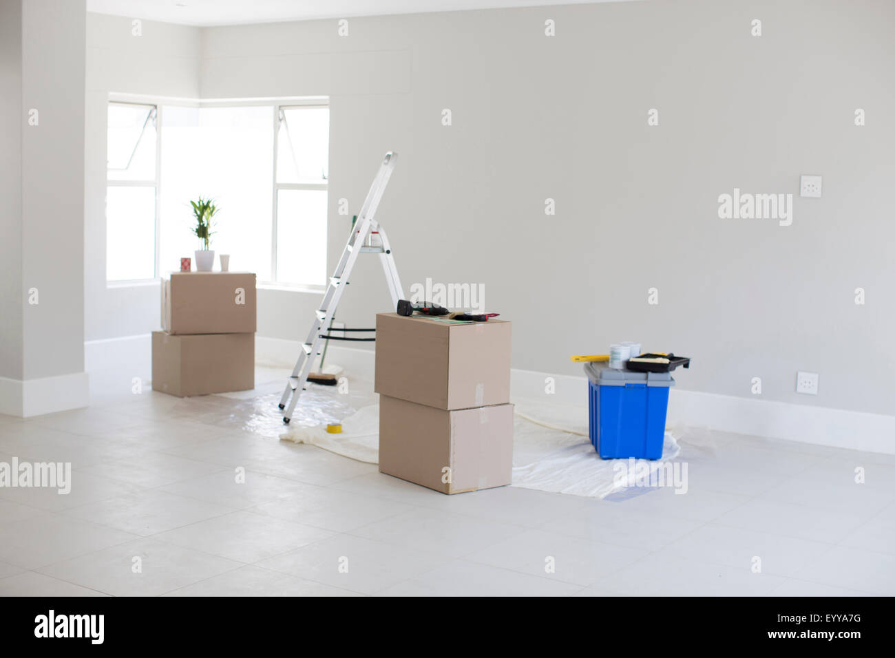 Cardboard boxes and ladder in new home Stock Photo