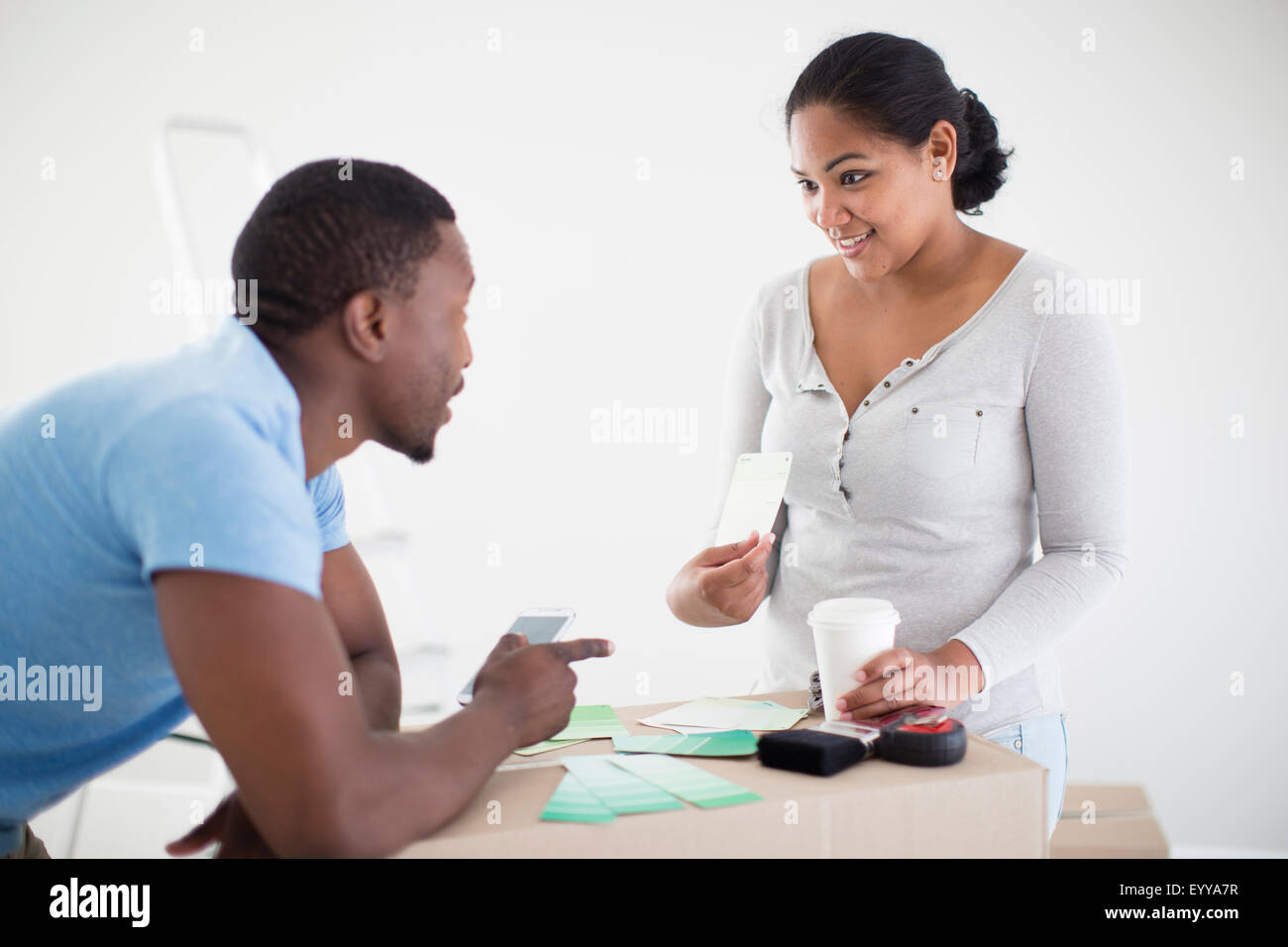 Couple choosing paint swatches in new home Stock Photo