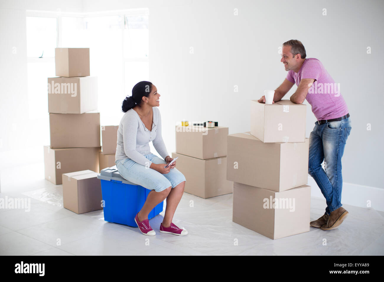 Couple with cardboard boxes in new home Stock Photo