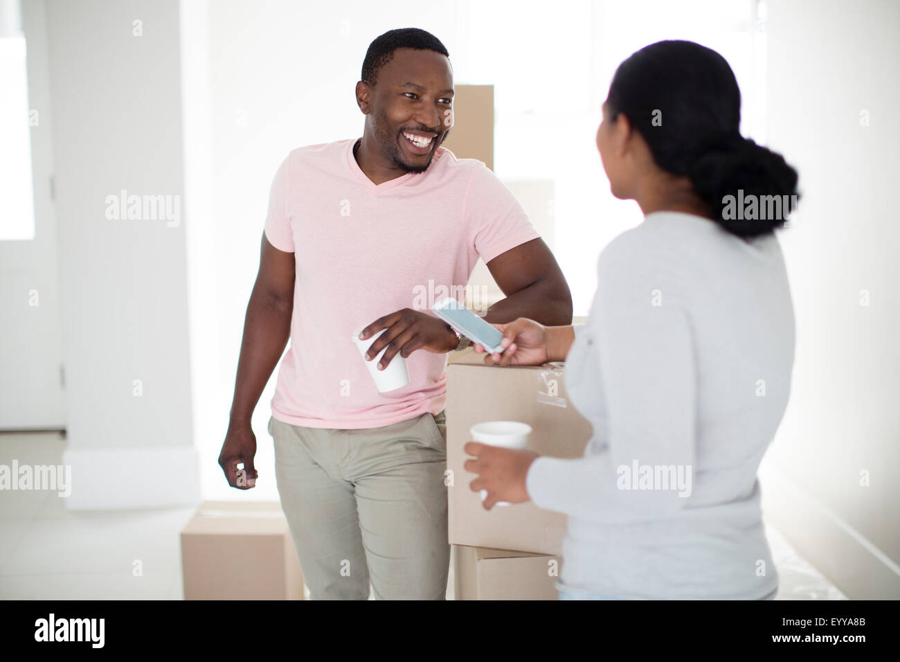 Couple with cardboard boxes in new home Stock Photo