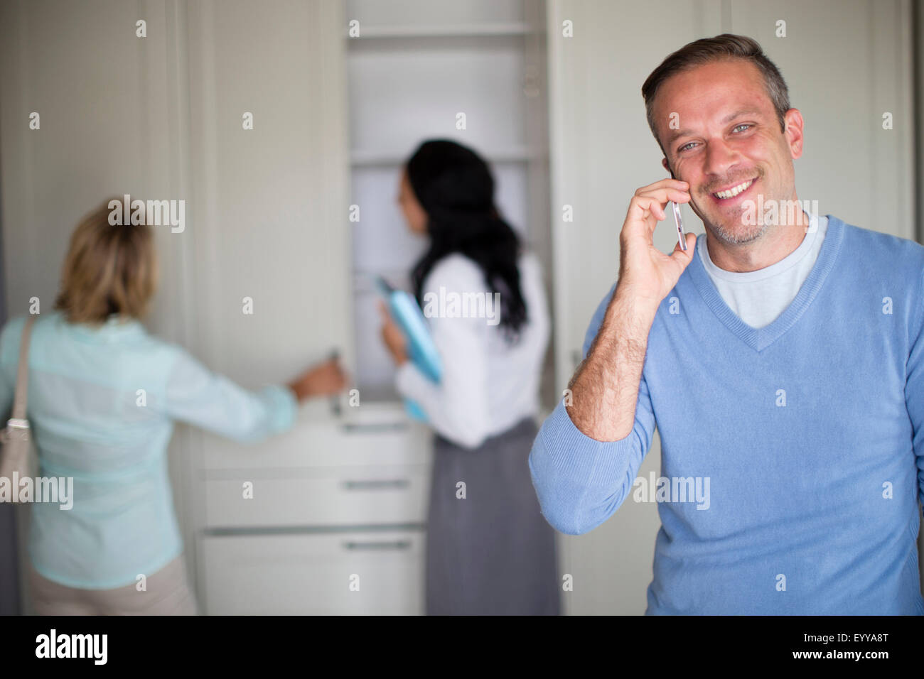 Man talking on cell phone in new home Stock Photo