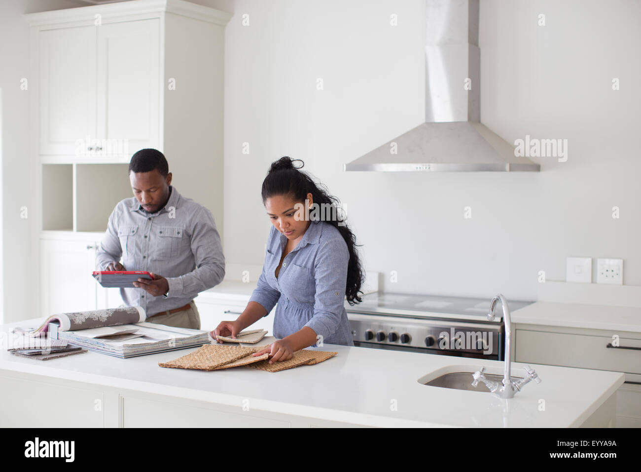 Couple examining fabric swatches in new home Stock Photo