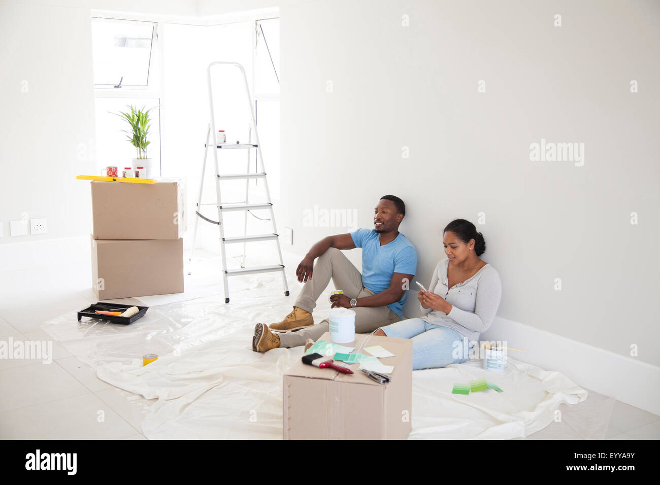 Couple relaxing in new home Stock Photo
