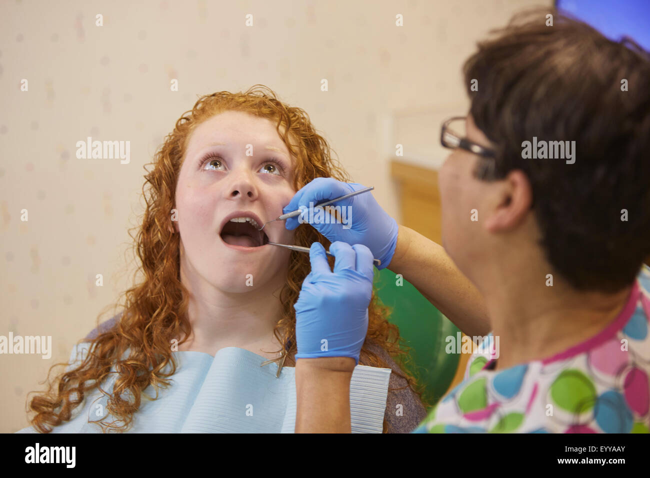 Pediatric dentist examining teeth of teenage patient Stock Photo