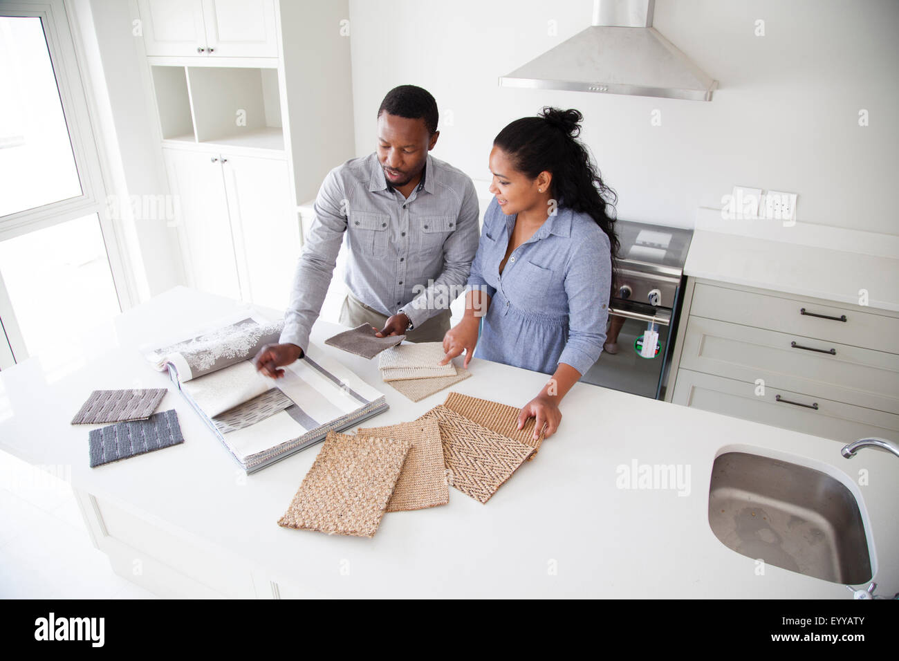 Couple examining fabric swatches in new home Stock Photo