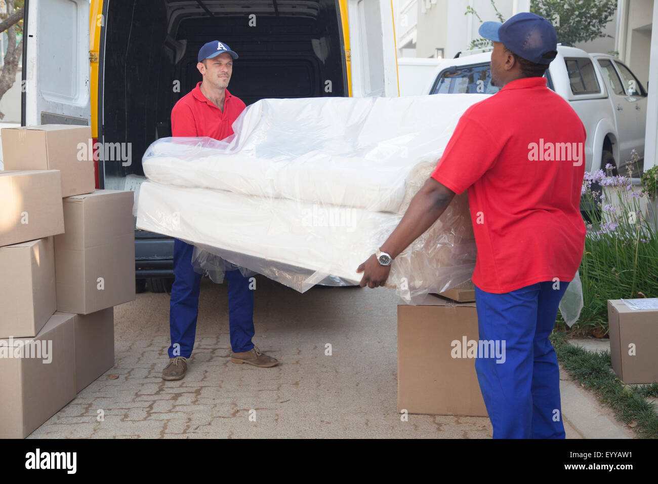 Movers carrying sofa to new home Stock Photo
