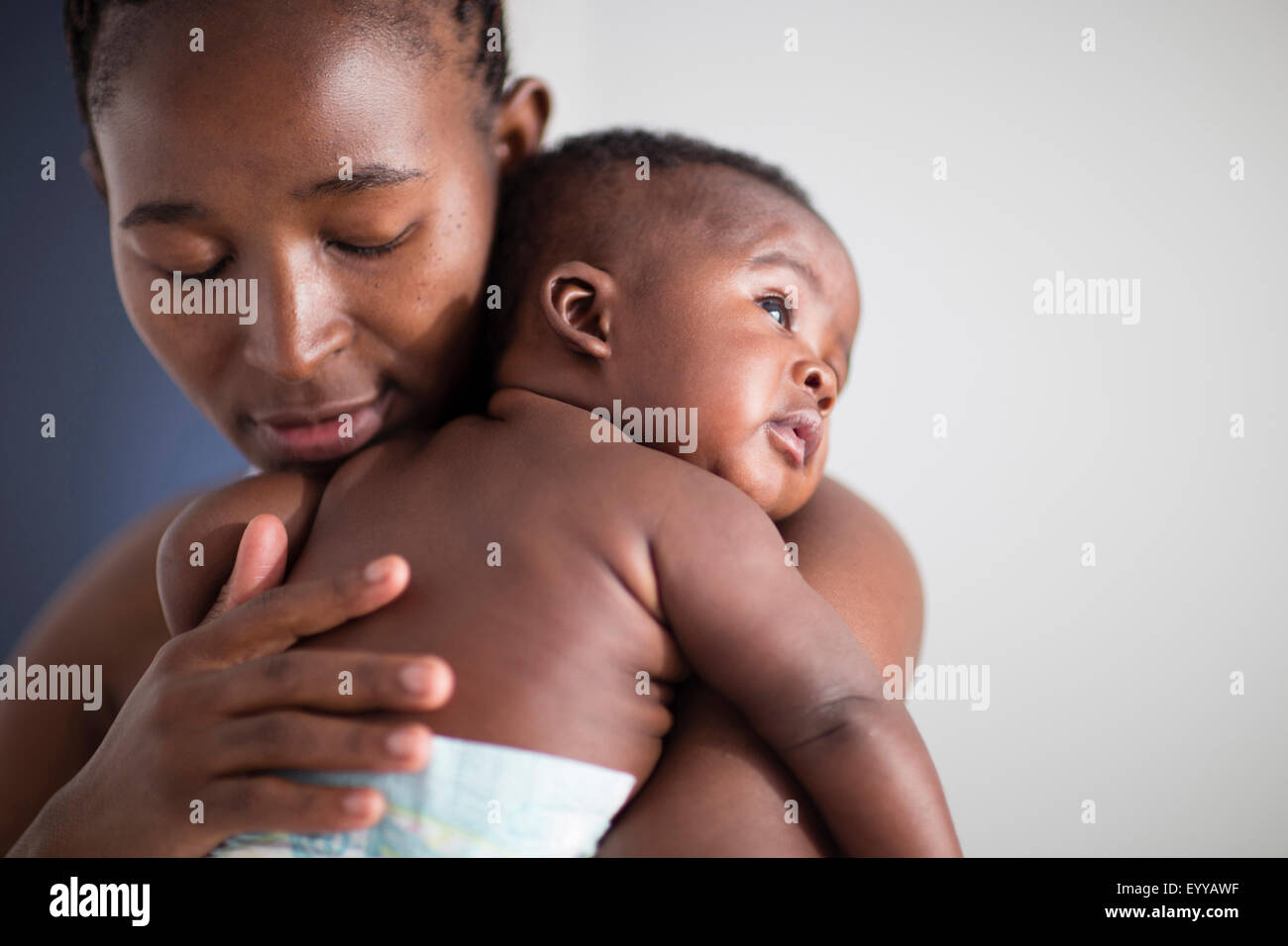 Close up of Black mother holding baby Stock Photo