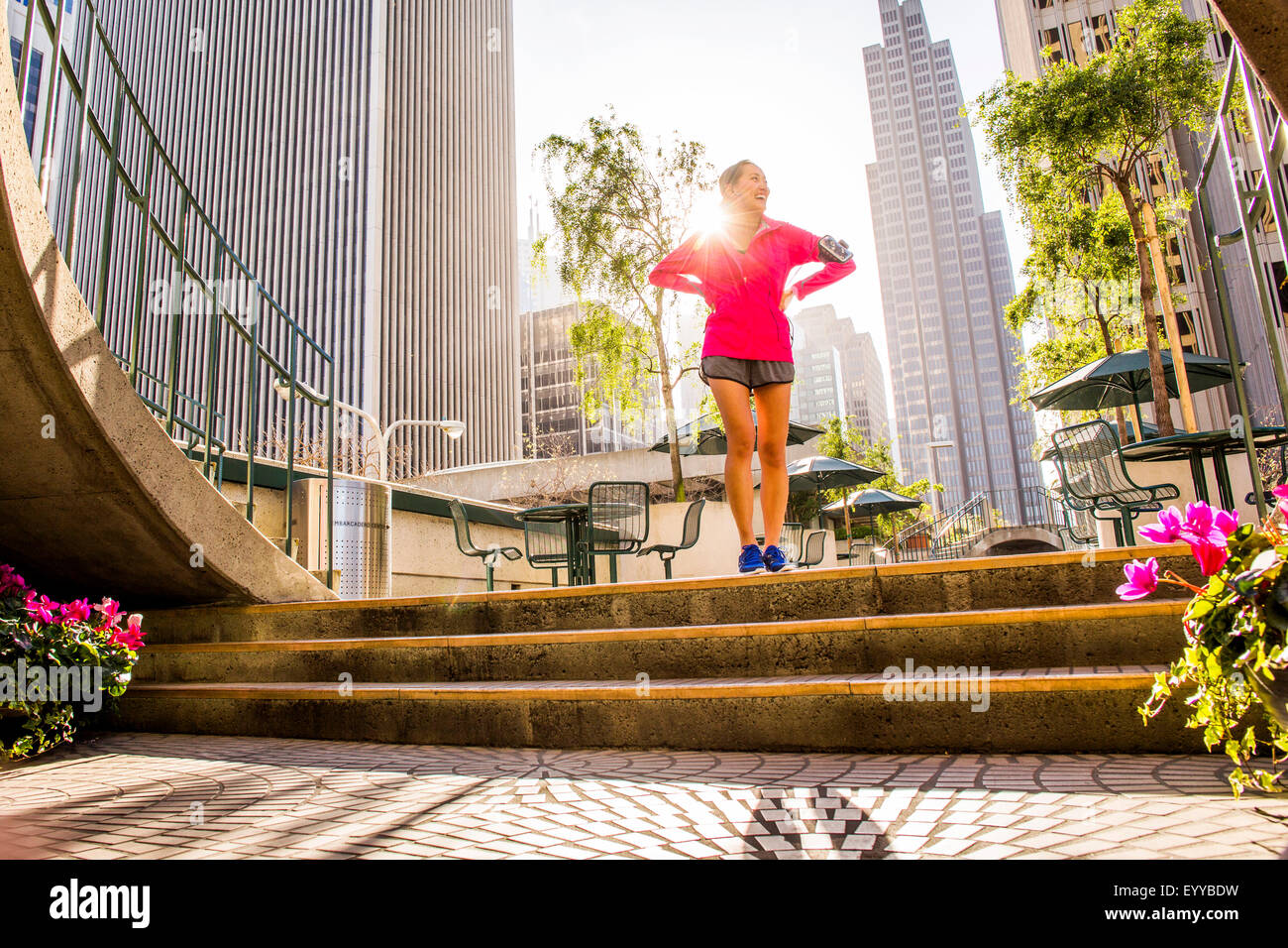 Runner standing on city steps near high rise buildings Stock Photo Alamy