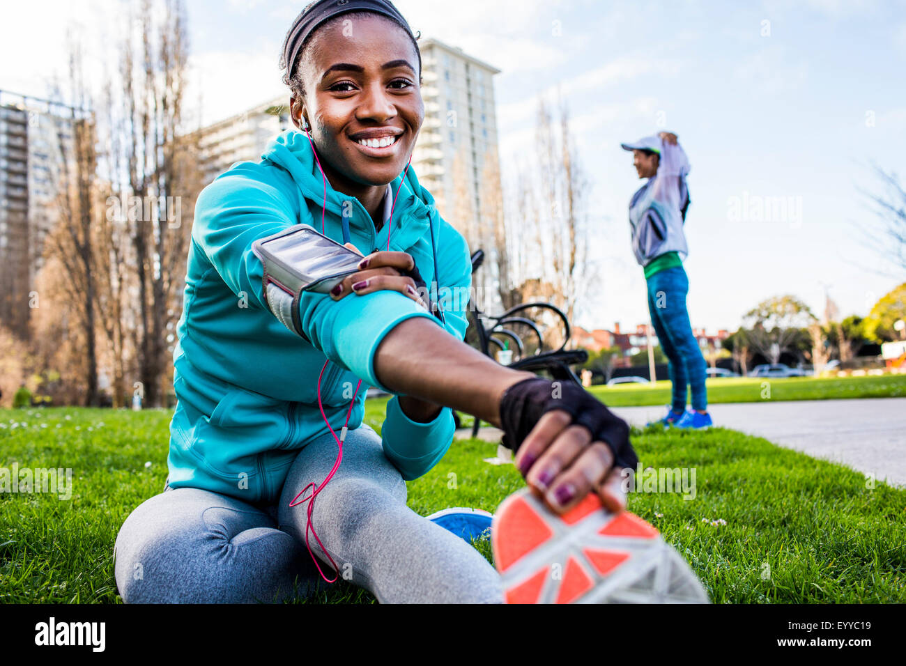 Runner stretching in urban park Stock Photo