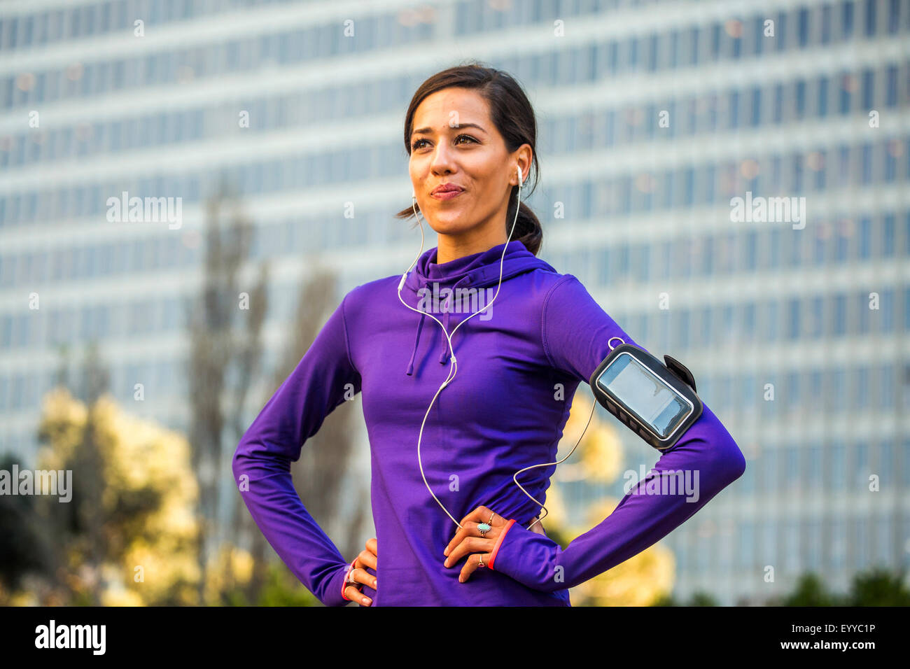 Hispanic runner standing near high rise building Stock Photo Alamy