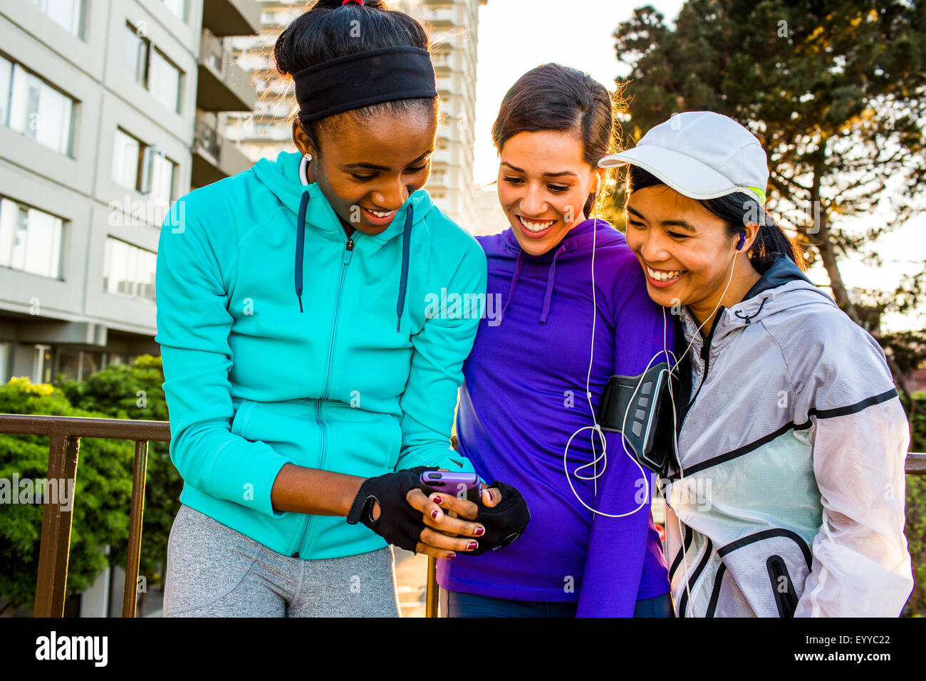 Runners using cell phone in city Stock Photo Alamy