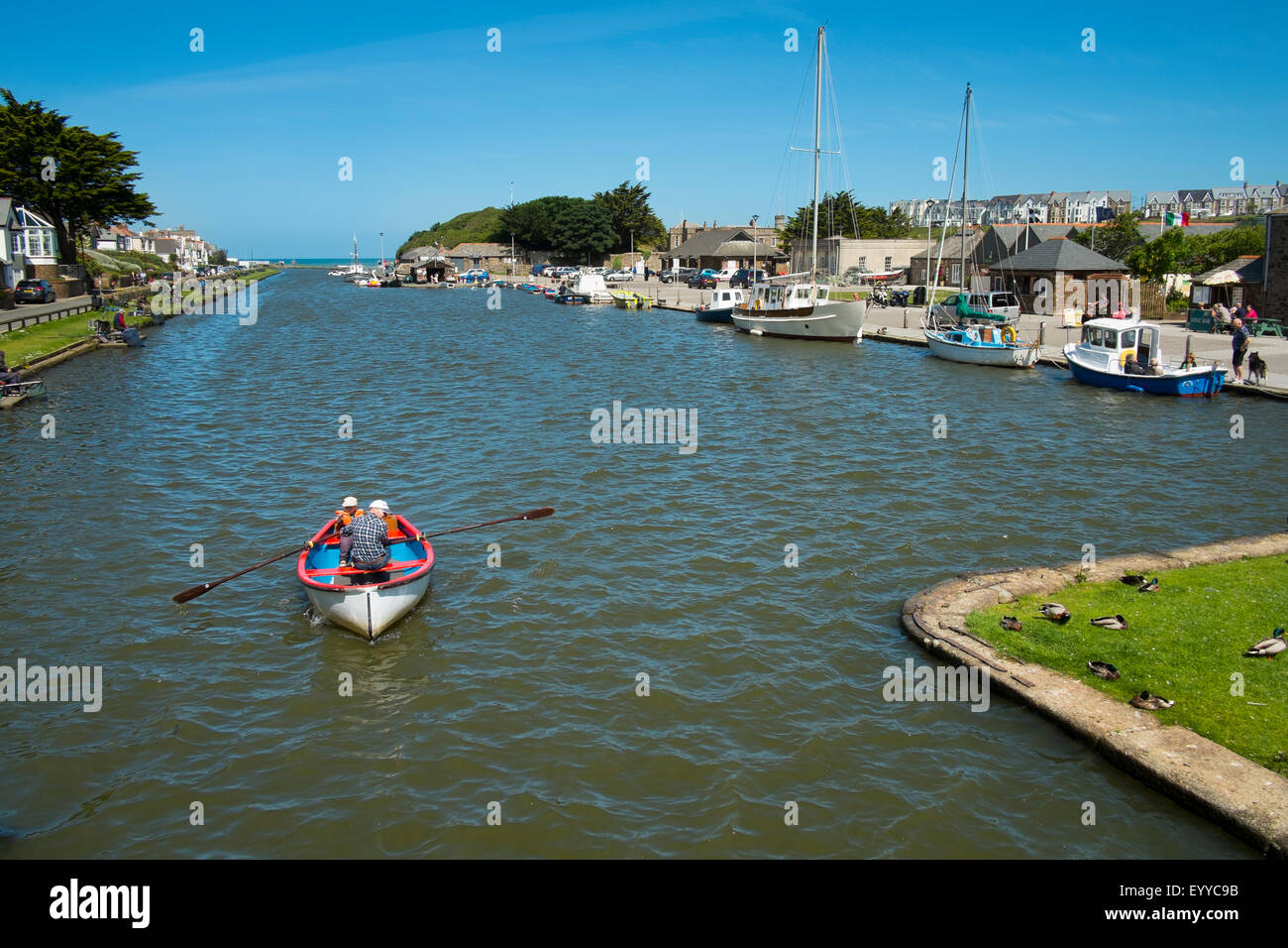 Two people in a rowing boat on the Bude Canal, Cornwall, England, UK