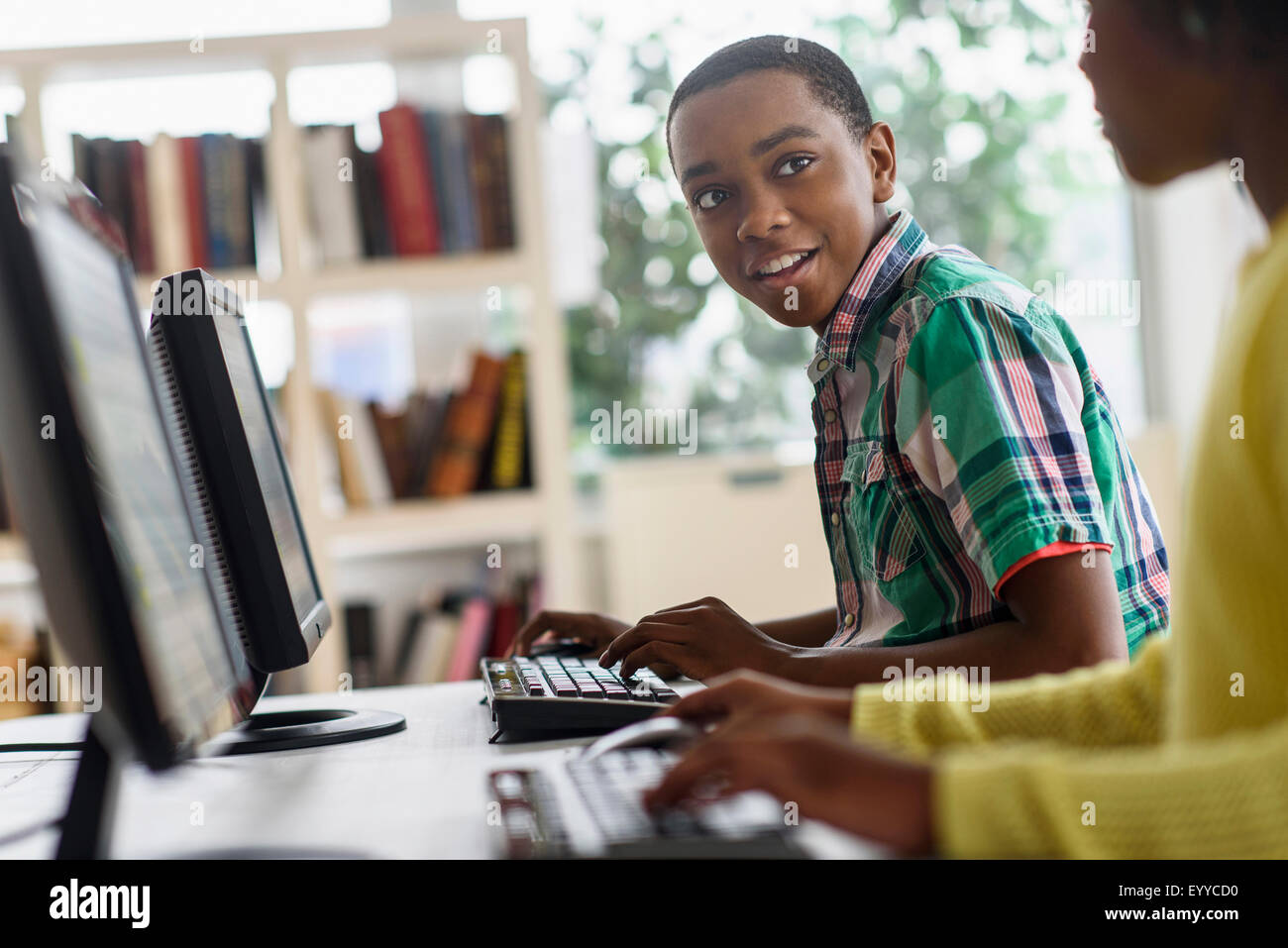 Black students using computers in classroom Stock Photo