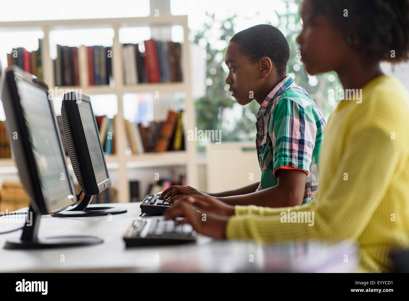 Black students using computers in classroom Stock Photo