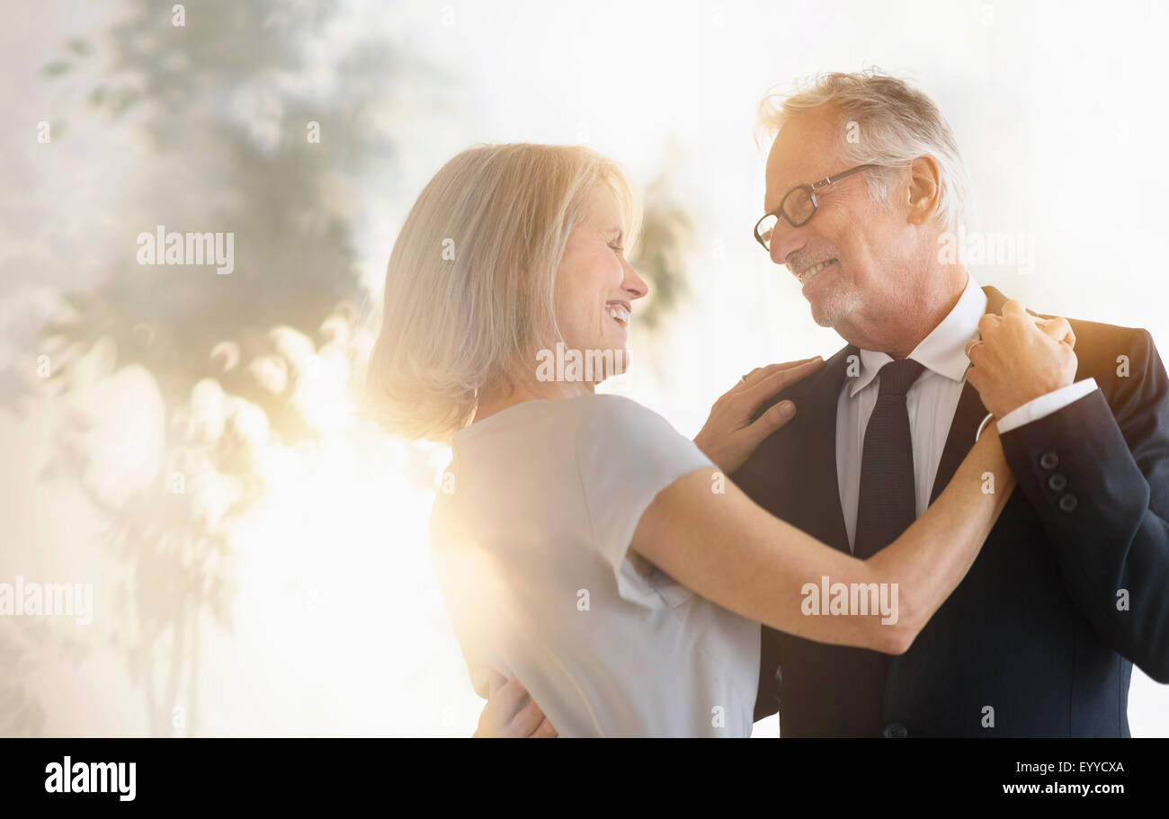 Smiling older Caucasian couple dancing Stock Photo