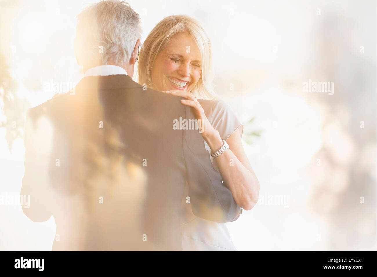 Smiling older Caucasian couple dancing Stock Photo