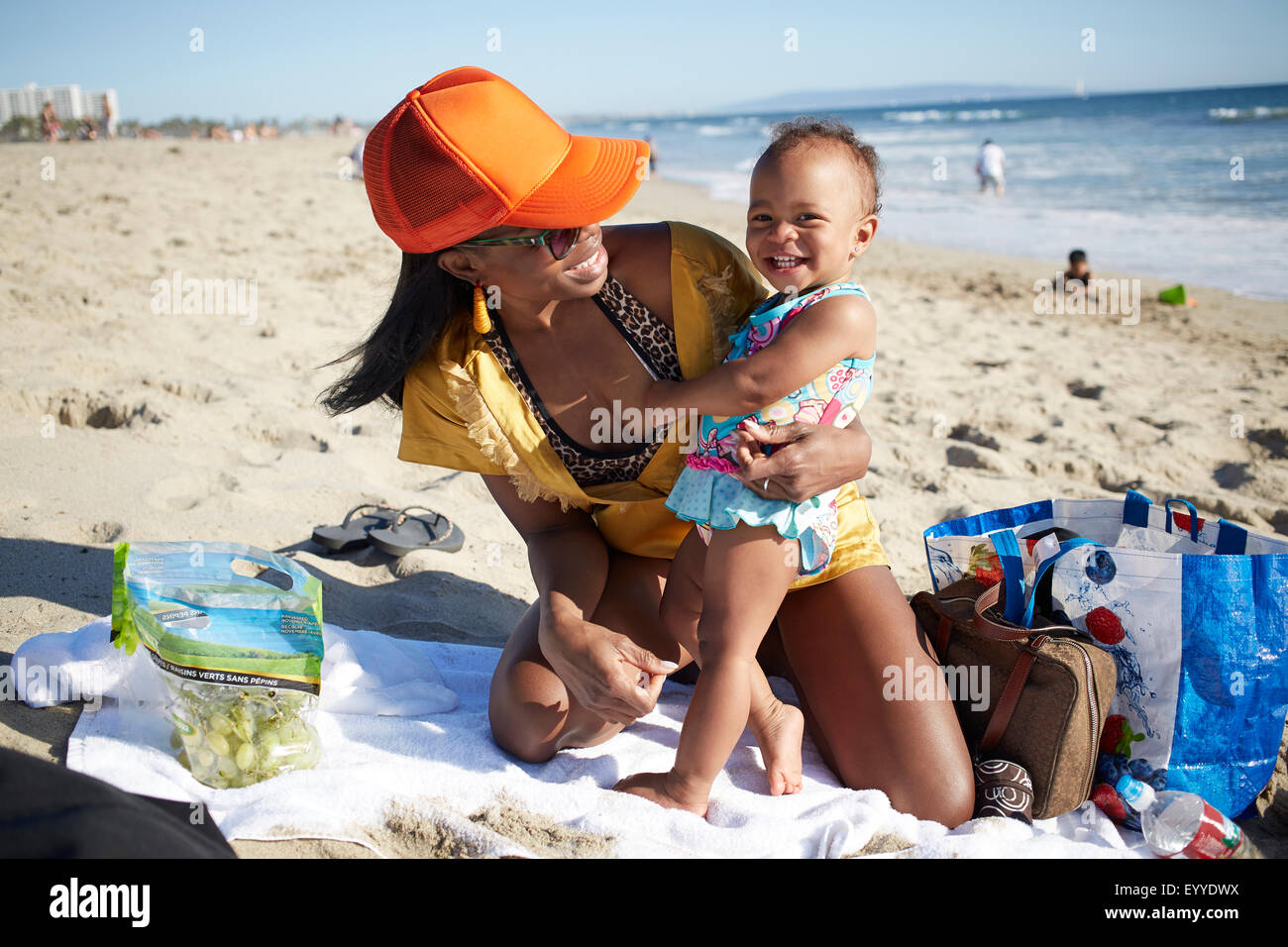 Mother and daughter playing on beach Stock Photo