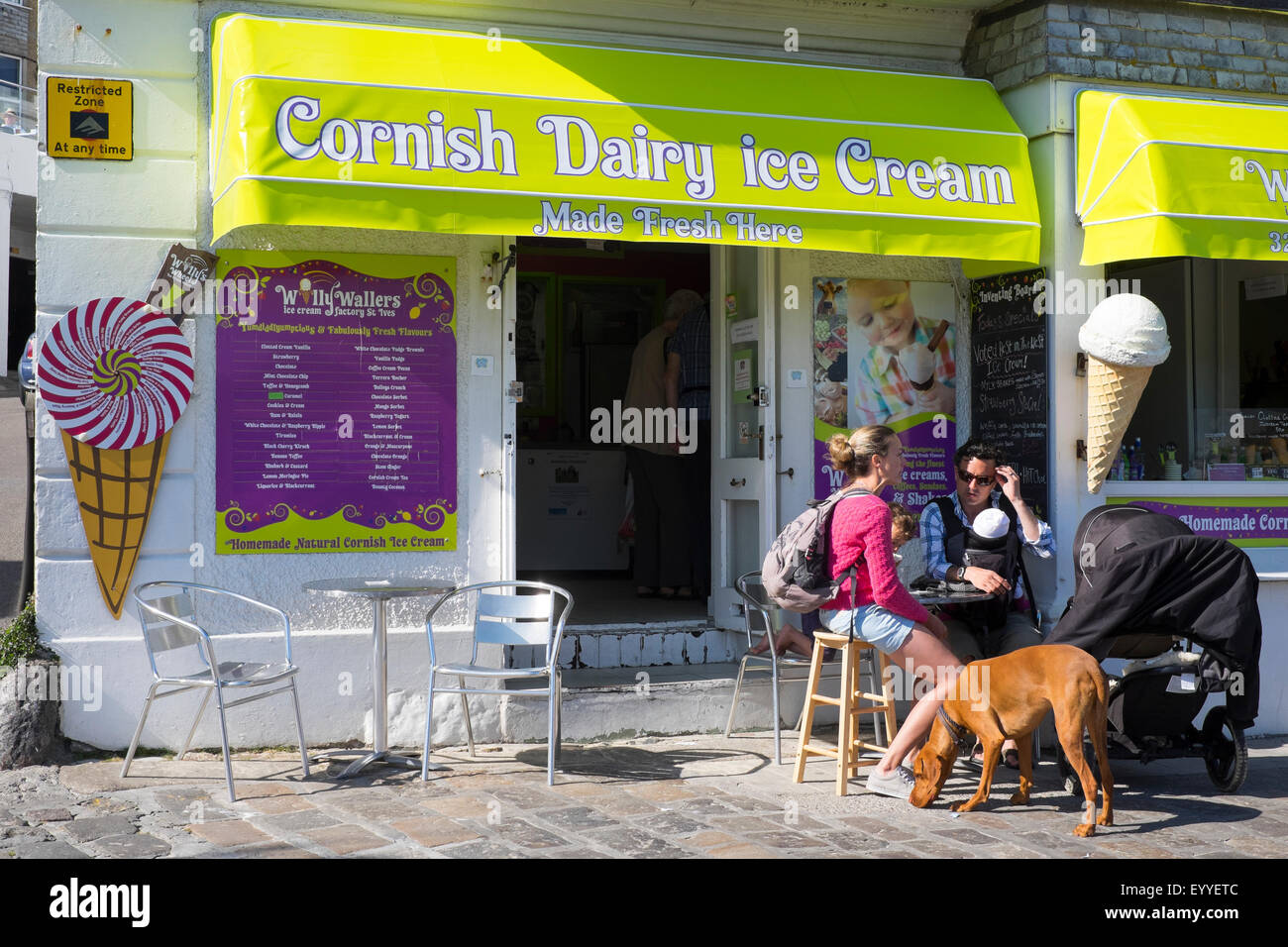 Family sitting outside Cornish dairy ice cream shop in St Ives