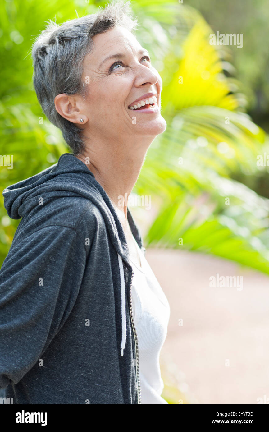 Smiling woman standing outdoors Stock Photo