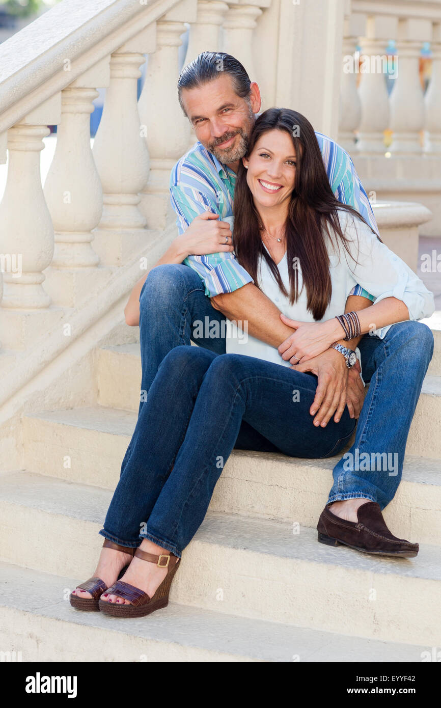 Caucasian couple hugging on front stoop Stock Photo
