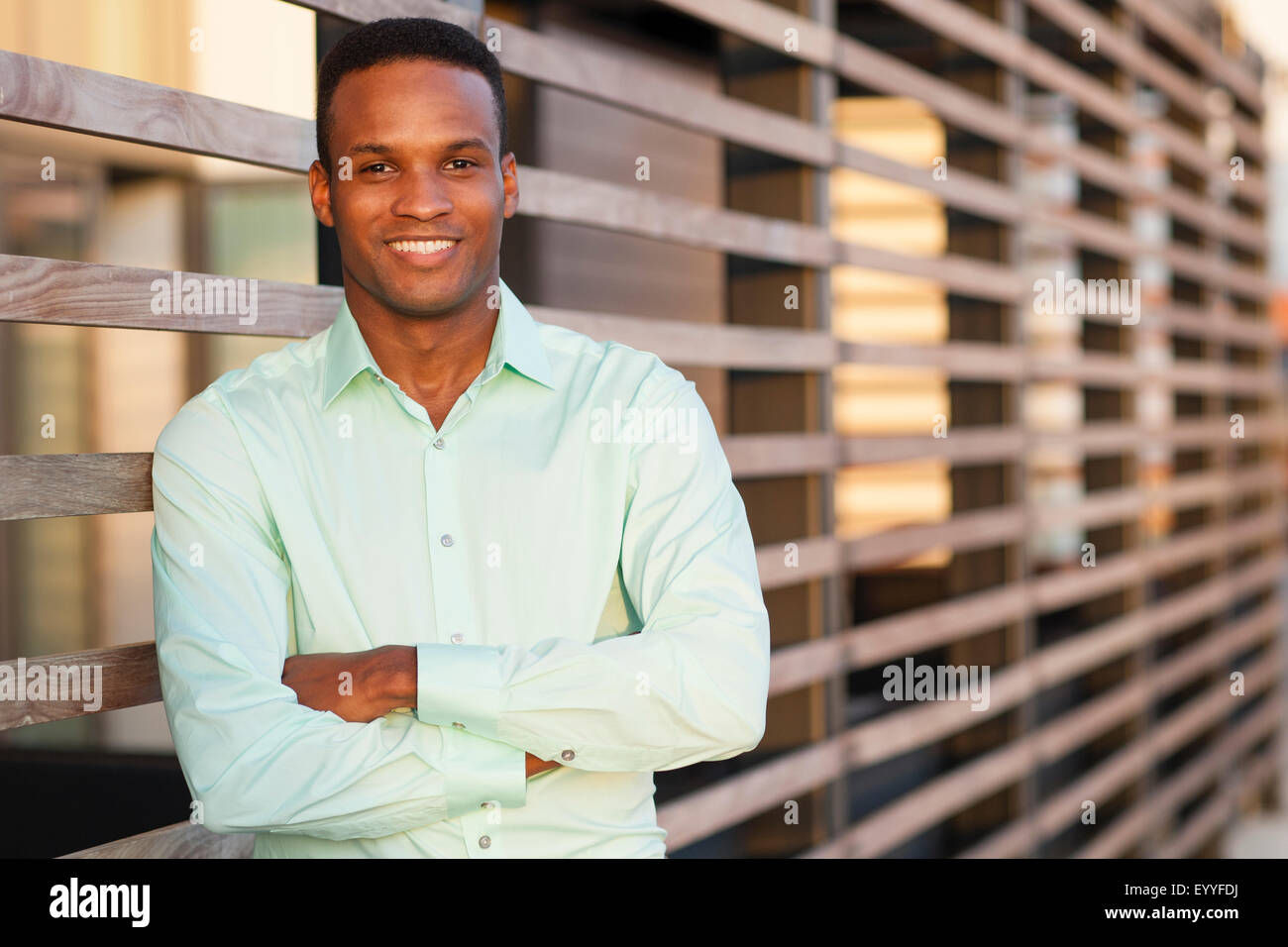 Black businessman standing with arms crossed Stock Photo
