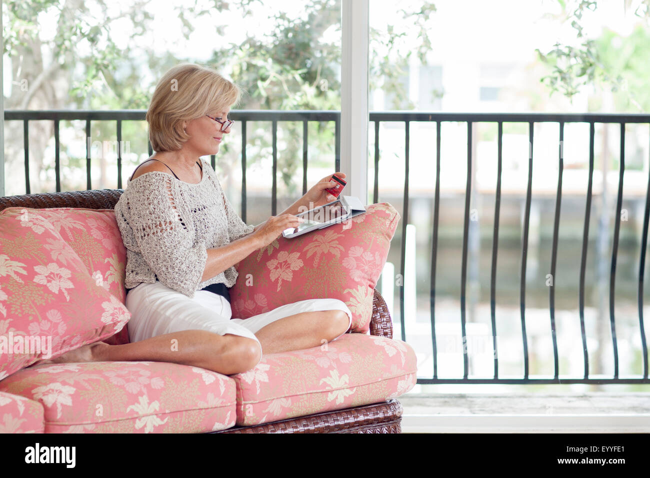 Caucasian woman using digital tablet on sofa Stock Photo